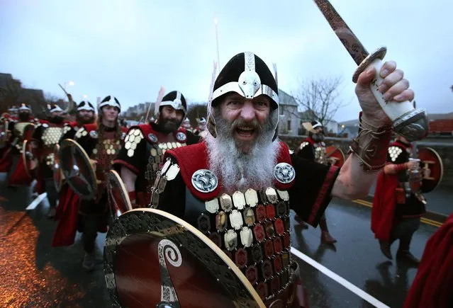 Members of the Jarl Squad dressed in Viking costumes march through the streets of Lerwick on the Shetland Isles in Scotland, during the Up Helly Aa festival  on Tuesday January 26, 2016. Originating in the 1880s, the festival celebrates Shetland's Norse heritage. (Photo by Andrew Milligan/PA Wire via AP Photo)