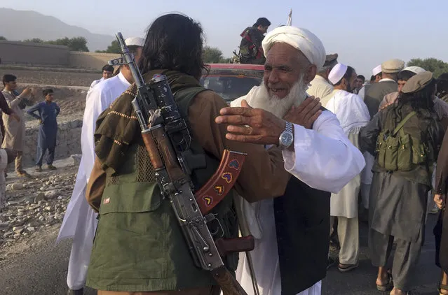 In this June 16, 2018 file photo, Taliban fighters gather with residents to celebrate a three-day cease fire marking the Islamic holiday of Eid al-Fitr, in Nangarhar province, east of Kabul, Afghanistan. On Sunday, August 19, 2018, Afghan President Ashraf Ghani announced a conditional cease-fire with Taliban insurgents for the duration of the Eid al-Adha holiday. Ghani made the announcement Sunday during celebrations of the 99th anniversary of Afghanistan's independence. (Photo by Rahmat Gul/AP Photo)