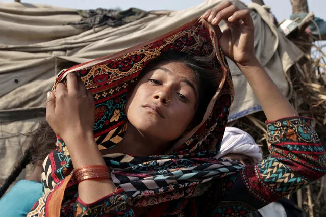 In this Tuesday, December 20, 2016 photo, Saima, who married an older man in her early teens, fixes her scarf during an interview in Jampur, Pakistan. (Photo by K.M. Chaudhry/AP Photo)