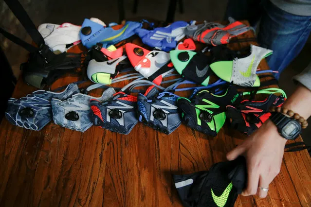 Designer Wang Zhijun arranges the face masks he made using sneakers, to be photographed in Beijing, China December 21, 2016. (Photo by Damir Sagolj/Reuters)