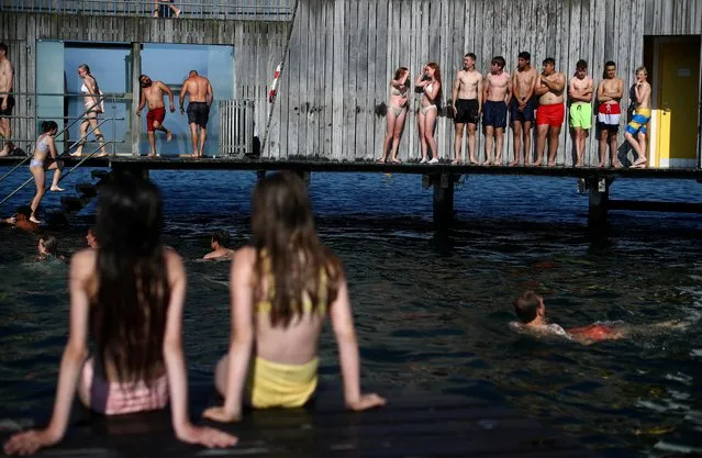 People enjoy warm weather at the Kastrup Sea Bath in Copenhagen, Denmark, June 19, 2021. (Photo by Hannah McKay/Reuters)