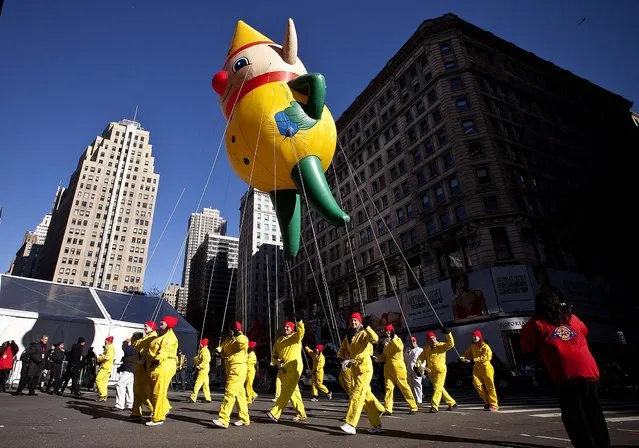 A Santa's Elf balloon floats above the street. (Photo by Kena Betancur/Getty Images)