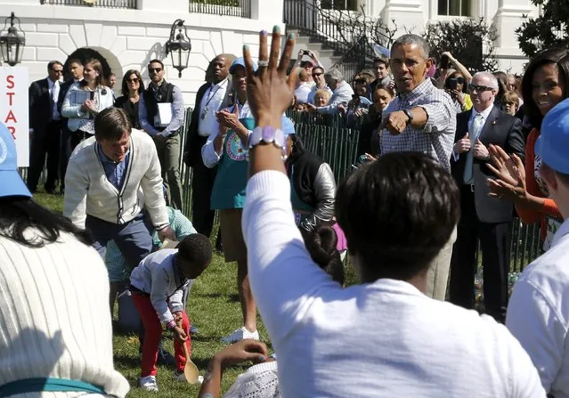 U.S. President Barack Obama (2nd R) and first lady Michelle Obama (R) cheer on children during the annual Easter Egg Roll at the White House in Washington April 6, 2015. (Photo by Jonathan Ernst/Reuters)