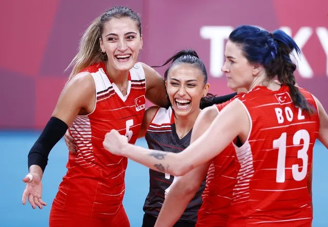 Simge Sebnem Akoz, Meryem Boz and Seyma Ercan of Turkey celebrate after winning the fourth set against Team South Korea during the Women's Quarterfinals volleyball on day twelve of the Tokyo 2020 Olympic Games at Ariake Arena on August 04, 2021 in Tokyo, Japan. (Photo by Carlos Garcia Rawlins/Reuters)
