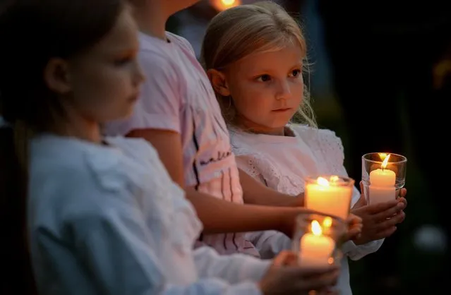 Hollie holds a candle during the candlelit vigil at North Down Crescent Park on August 13, 2021 in Plymouth, England. (Photo by Finnbarr Webster/Getty Images)