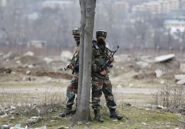 Indian Army personnel take position near the Entrepreneurship Development Institute (EDI) building, in Sempora Pampore, some 15 km south of Srinagar, the summer capital of Indian Kashmir, 20 February 2016. A Central Reserve Police Force (CRPF) officer was killed and others injured after militants stormed the EDI, and opened fire, according to news reports. Around 30 employees and 160 candidates being trained were trapped and later evacuated. (Photo by Farooq Khan/EPA)