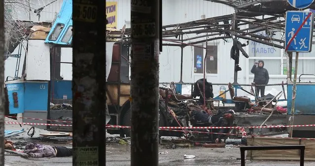 Dead bodies lie at the scene where a destroyed trolleybus stands on a street in Volgograd on December 30, 2013 after ten people were killed in a bombing on the packed vehicle, the second attack in the city in two days after a suicide strike on its main train station, officials said. The new attack will further heighten fears about security at the Winter Olympic Games which are due to open on February 7 in Russia's Black Sea resort of Sochi, which lies 690 kilometres (425 miles) southwest of Volgograd. (Photo by Kirill Braga/RIA Novosti)
