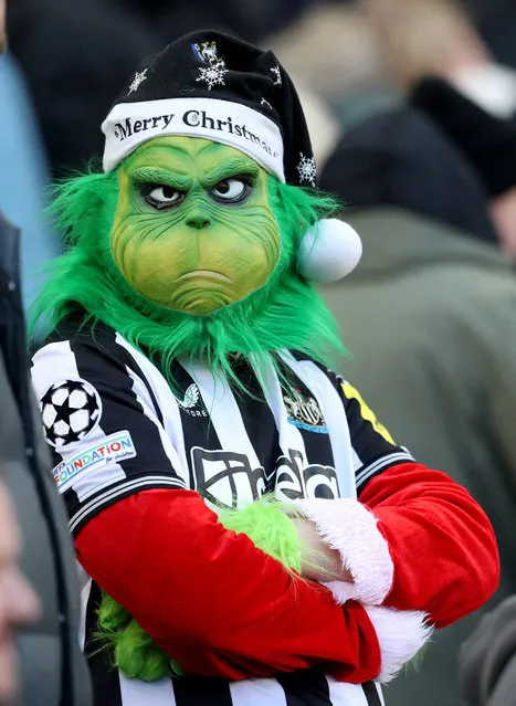 A Newcastle United's fan wearing a Grinch mask attends the English Premier League football match between Newcastle United and Nottingham Forest at St. James' Park in Newcastle-upon-Tyne, England on December 26, 2023. (Photo by Scott Heppell/Reuters)
