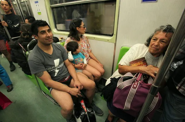 Commuters participate in the annual event, No Pants Subway Ride, in Mexico City, Sunday, January 12, 2014. (Photo by Marco Ugarte/AP Photo)