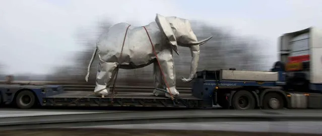 A life-size metal sculpture of an elephant is transported on a trailer near Lahr, southern Germany, Wednesday, January 25, 2017. The elephant was transported from a drive-in cinema to Avignon, France. (Photo by Patrick Seeger/dpa via AP Photo)