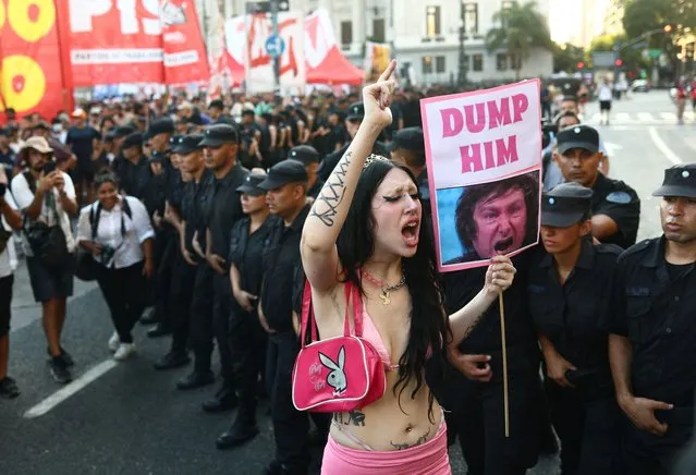 A demonstrator holds up a sign with a picture of Argentina's President Javier Milei during a protest as lawmakers debate Milei's economic reform bill, known as the “omnibus bill”, outside the National Congress in Buenos Aires, Argentina, on February 1, 2024. (Photo by Matias Baglietto/Reuters)