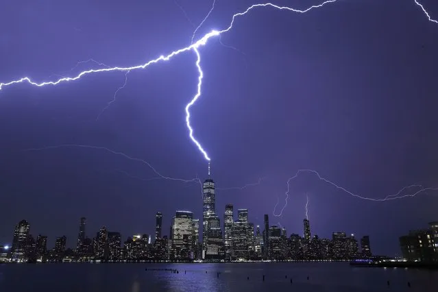Lightning strikes One World Trade Center in New York City during a thunderstorm on September 13, 2021 as seen from Jersey City, New Jersey. (Photo by Gary Hershorn/Getty Images)