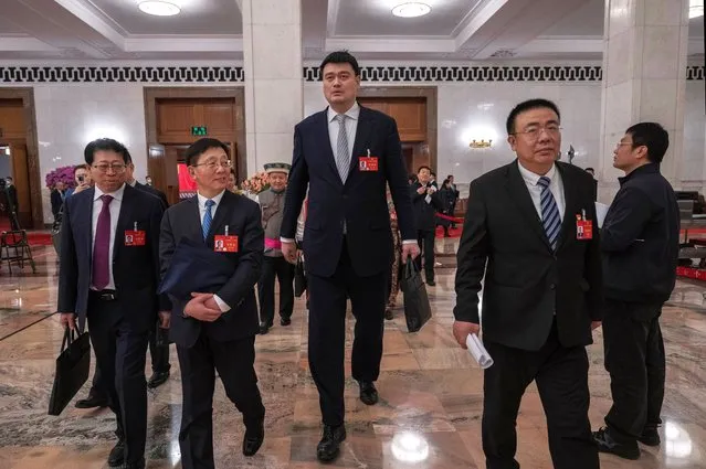 Former NBA player and NPC delegate Yao Ming, center, walks with others as he leaves the second plenary session of the National Peoples Congress at the Great Hall of the People on March 8, 2024 in Beijing, China. China's annual political gathering known as the Two Sessions convenes leaders and lawmakers to set the government's agenda for domestic economic and social development for the year. (Photo by Kevin Frayer/Getty Images)