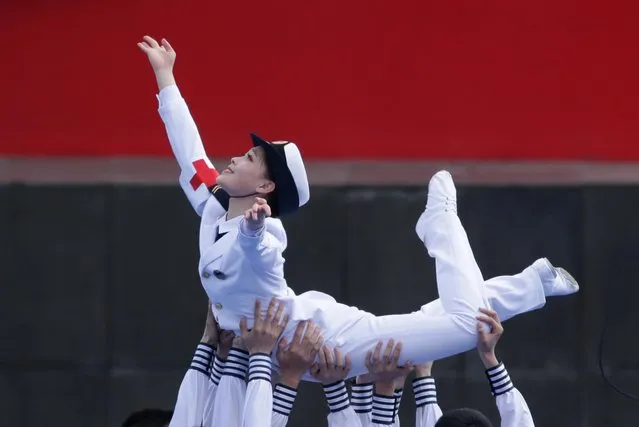 A Chinese military dance troupe performs during a concert featuring Chinese and foreign military bands in Qingdao, Monday, April 22, 2019. Ships from Chinese and foreign navies have gathered in Qingdao for events this week, including a naval parade, to mark the 70th anniversary of the founding of the People's Liberation Army (PLA) Navy. (Photo by Jason Lee/Reuters)
