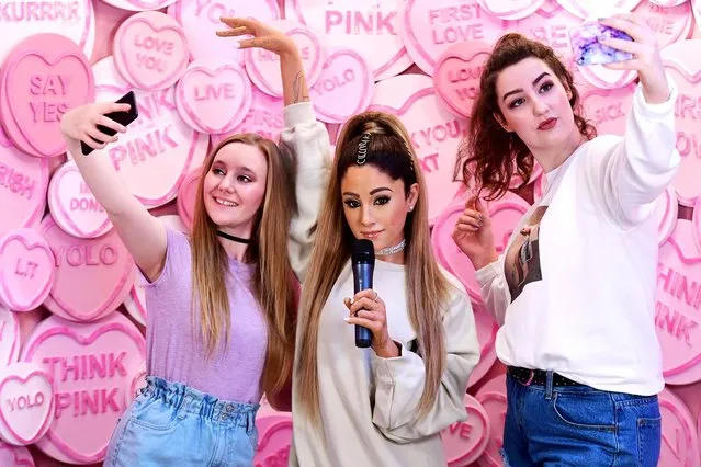 Heather (left) and Grace pose with the waxwork of Ariana Grande at the unveiling of Ariana Grande's wax figure at Madame Tussauds, London on May 20, 2019. (Photo by Ian West/PA Wire Press Association)