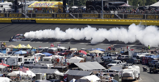Jamie Dick (55) loses an engine as smoke pours from his car in Turn 2 during the NASCAR Xfinity series auto race at Charlotte Motor Speedway in Concord, N.C., Saturday, May 23, 2015. (Photo by Gerry Broome/AP Photo)
