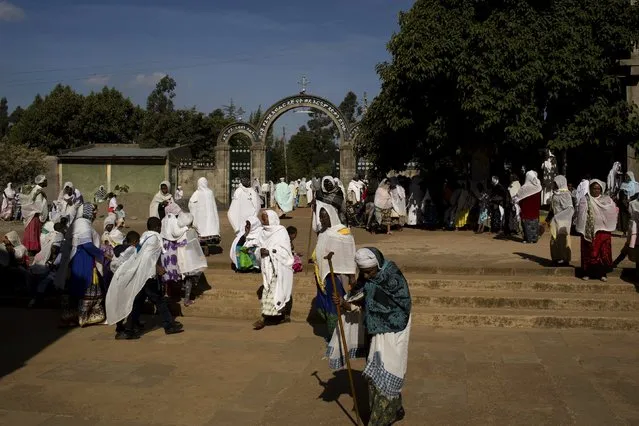 Christian Orthodox faithful pray and walk outside a church during Sunday morning mass in Addis Ababa, Ethiopia, May 17, 2015. (Photo by Siegfried Modola/Reuters)