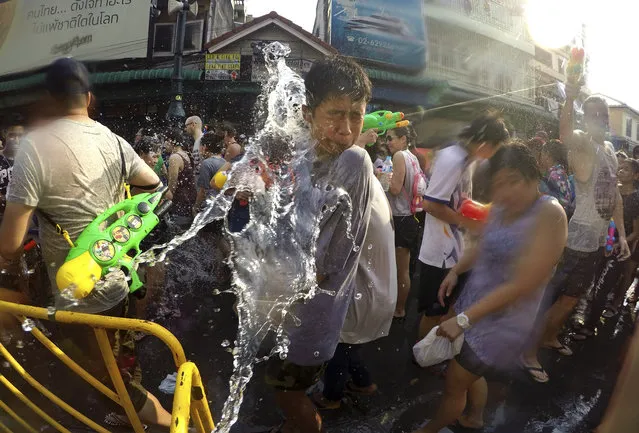 Local and foreign revelers douse each other with water during the Songkran water festival in a popular tourist area of Bangkok, Thailand, Wednesday, April 13, 2016. Bangkok, Thailand. The Songkran festival, also known as the Thai New Year or Thailand Water Festival, was originally celebrated as a way to offer good fortune to elders and pay their respects to the beloved Buddha. (Photo by Jason Corben/AP Photo)