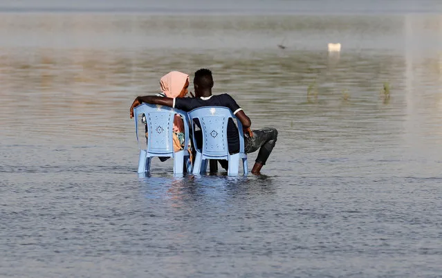 A Sudanese couple enjoy the shallow waters of the Nile River in Khartoum, Sudan, April 24, 2019. (Photo by Umit Bektas/Reuters)
