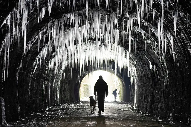 Icicles hang from the roof of the Hopton Tunnel on the High Peak Trail in Derbyshire on February 12, 2021 in Matlock, England. Hopton Tunnel is former railway tunnel near the village of Hopton, Derbyshire. The rail line was closed in 1967 and is now part of the High Peak walking and cycling trail. Many areas of the uk has seen freezing temperatures and high winds in the South West coastal regions as the cold snap continues. (Photo by Christopher Furlong/Getty Images)