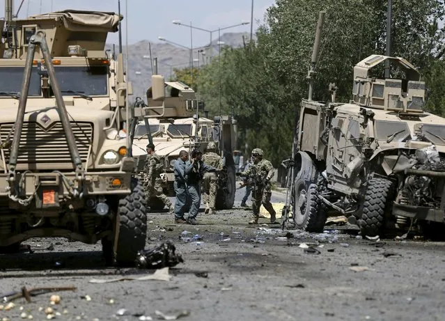 U.S. soldiers inspect the site of a suicide attack in Kabul, Afghanistan June 30, 2015. (Photo by Mohammad Ismail/Reuters)