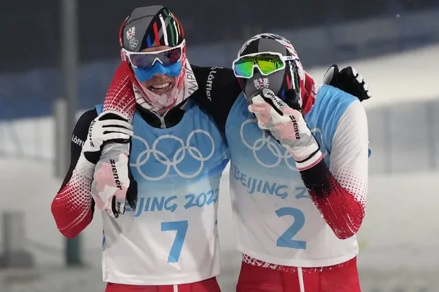 Austria's Franz-Josef Rehrl, left, celebrates with bronze medal finisher Austria's Lukas Greiderer, right, after the cross-country skiing portion of the individual Gundersen normal hill/10km event at the 2022 Winter Olympics, Wednesday, February 9, 2022, in Zhangjiakou, China. (Photo by Alessandra Tarantino/AP Photo)