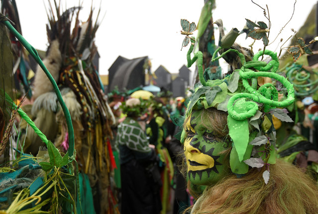 Participants take part in the annual Jack In The Green parade involving hundreds of costumed revellers joining a four hour procession culminating in the traditional “slaying” of a Jack character to “unleash the spirit of summer” on the May Day week end, in Hastings, southern Britain, May 2, 2016. (Photo by Toby Melville/Reuters)