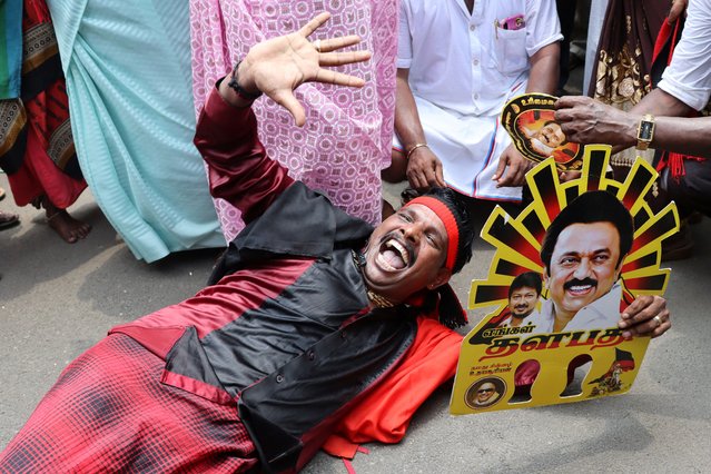 A supporter holds a cut-out of the Dravida Munnetra Kazhagam (DMK) party symbol with the image of M.K. Stalin during celebrations after the initial general election results, outside party headquarters in Chennai, India, on June 4, 2024. (Photo by Riya Mariyam Raju/Reuters)