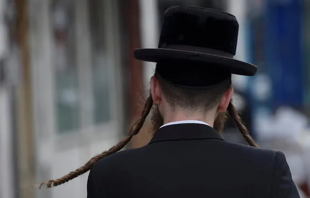 An orthodox Jewish man walks through a street in Stamford Hill north London, Britain May 3, 2016. (Photo by Hannah McKay/Reuters)