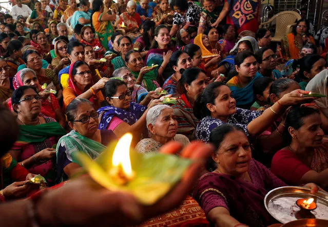 Hindu devotees carry oil lamps and perform prayers on the occasion of Ramnavmi festival inside a temple in Ahmedabad, April 5, 2017. (Photo by Amit Dave/Reuters)