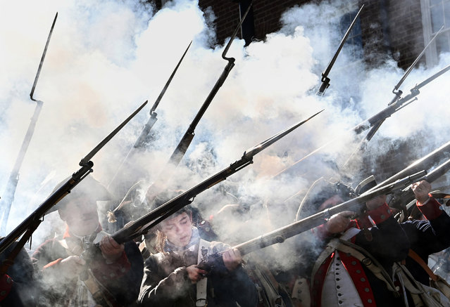 Members of the 1st Virginia Regiment of the Continental Army put on a firing display while taking part in the George Washington Birthday Parade on Monday February 21, 2022 in Alexandria, VA. (Photo by Matt McClain/The Washington Post)