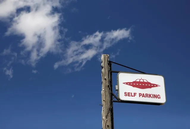 A parking sign at the Little A'Le'Inn in Rachel, Nevada, U.S. September 19, 2019. Visitors established a small encampment outside Rachel's only business - the extraterrestrial-themed Little A'Le'Inn motel and restaurant – parking themselves in cars, tents and RVs. Some tourists hung inflatable aliens from their campers. Music was scheduled to begin Thursday night and continue for two more days. It remained unclear if there would be a mass trek to the grounds of Area 51 on Friday. (Photo by Jim Urquhart/Reuters)