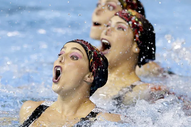 Members of Brazil's synchronized swimming team perform during technical routine competition for the Pan Am Games in Toronto, Thursday, July 9, 2015. (Photo by Gregory Bull/AP Photo)