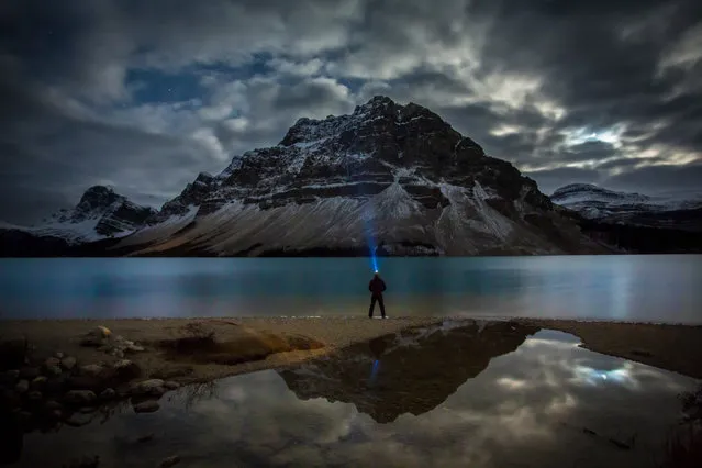 Paul Zizka in “Twilight Encounter”, Bow Lake, Banff National Park, Alberta, Canada, October 11, 2013. (Photo by Paul Zizka/Caters News)