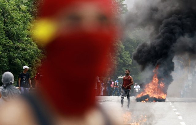 Demonstrators set a barricade on fire during a protest against Venezuelan President Nicolas Maduro's government in Valencia, Carabobo state, Venezuela on July 29, 2024, a day after the Venezuelan presidential election. Protests erupted in parts of Caracas Monday against the re-election victory claimed by Venezuelan President Nicolas Maduro but disputed by the opposition and questioned internationally, AFP journalists observed. (Photo by Juan Carlos Hernandez/AFP Photo)