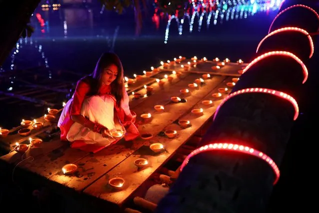 A devotee lights oil lamps as she takes part in Diwali celebrations in Dhaka, Bangladesh, October 27, 2019. (Photo by Mohammad Ponir Hossain/Reuters)