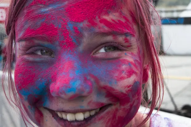 A girl is covered in colored paint during the Festival of Colours in Moscow, Russia, Sunday, June 12, 2016.The festival, which is mainly celebrated during the Hindu spring festival Holi in some regions of India and Nepal, has become popular among people in other communities including Russia. (Photo by Alexander Zemlianichenko/AP Photo)