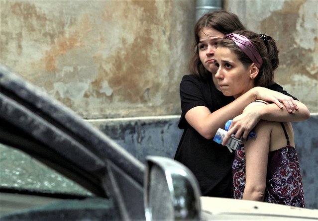 Local residents react at a site of a residential building hit by a Russian missile strike, amid Russia's attack on Ukraine, in Lviv, Ukraine on July 6, 2023. (Photo by Roman Baluk/Reuters)