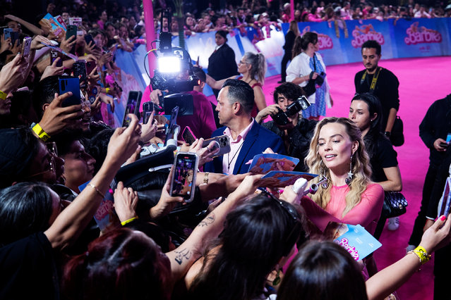 Australian actress Margot Robbie (R) signs autographs during the pink carpet event for the movie “Barbie”, at Parque Toreo Central, in Mexico City, Mexico on July 6, 2023. (Photo by Isaac Esquivel/EPA/EFE)