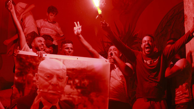 Supporters of Tunisian president and candidate for re-election Kais Saied celebrate after the announcement of the provisional results for the presidential elections, in the capital Tunis, Tunisia, Sunday, October 6, 2024. (Photo by Anis Mili/AP Photo)