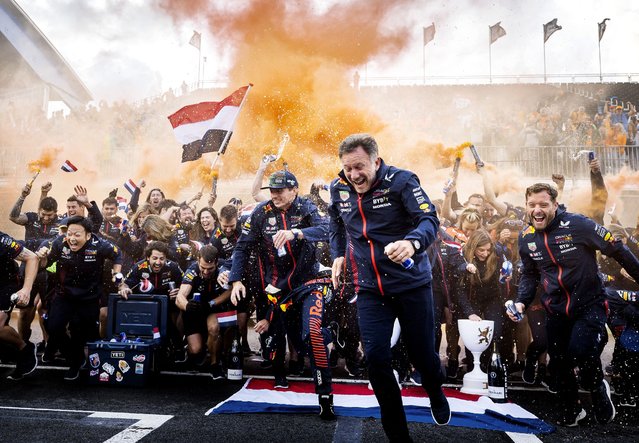 Red Bull Racing's Dutch driver Max Verstappen (C) and Red Bull Racing's British team principal Christian Horner (2R) celebrate with the members of the Red Bull Racing team after winning the Dutch Formula One Grand Prix race at The Circuit Zandvoort, in Zandvoort on August 27, 2023. (Photo by Koen van Weel/ANP via AFP Photo)