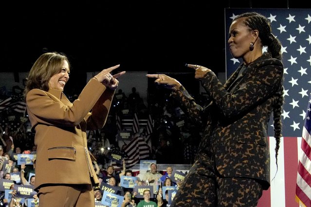 Democratic presidential nominee Vice President Kamala Harris, left, and former first lady Michelle Obama arrive to speak during a campaign rally at the Wings Event Center in Kalamazoo, Mich. on October 26, 2024 (Phoot by Jacquelyn Martin/AP Photo)