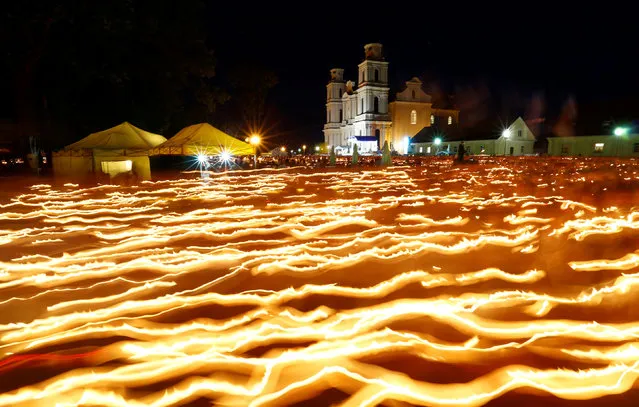 Catholics from Belarus and neighbouring countries carry candles during the annual Icon of the Mother of God procession in the village of Budslav, Belarus July 1, 2016. (Photo by Vasily Fedosenko/Reuters)