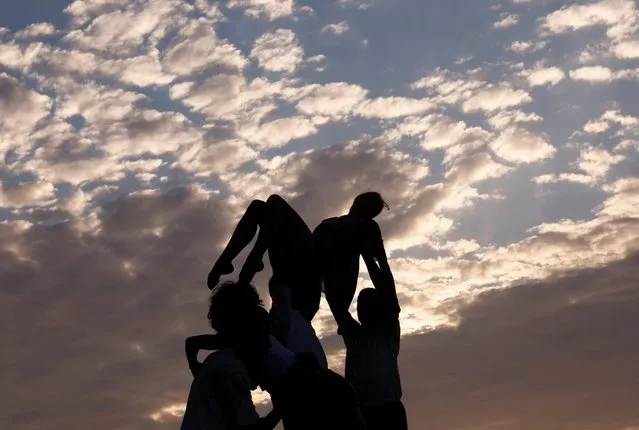 Dancers from ZfinMalta take part in a performance of Ola Gjeilo's “Sunrise Mass” for chorus and string orchestra at the 5000-year-old megalithic temple complex of Mnajdra outside Qrendi, Malta on June 18, 2022. (Photo by Darrin Zammit Lupi/Reuters)