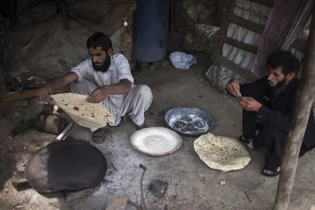 A miner cooks Pashtun roti (bread) after finishing his shift at a coal mine in Choa Saidan Shah, Punjab province, May 5, 2014. (Photo by Sara Farid/Reuters)