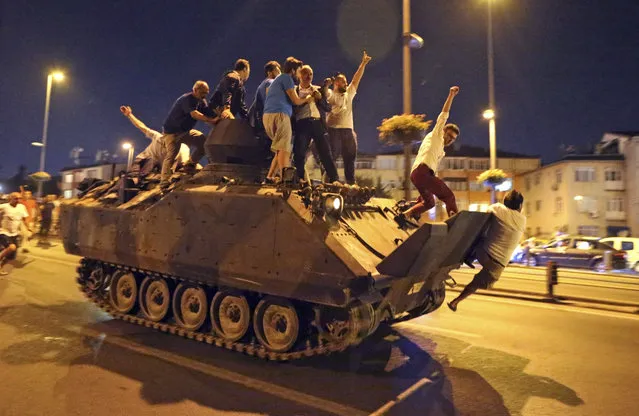 People occupy a tank in Istanbul, Turkey, 16 July 2016. (Photo by Tolga Bozoglu/EPA)