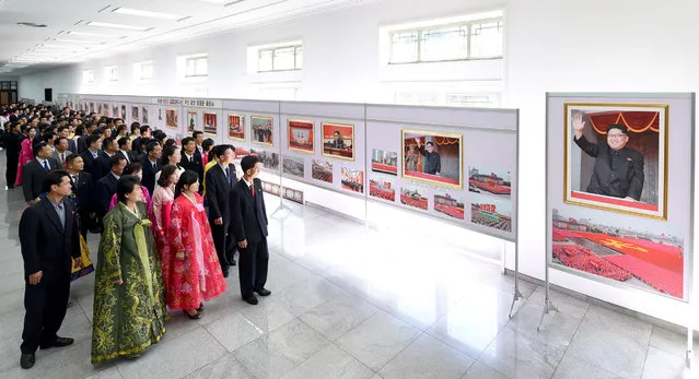 People view a photo exhibit marking the 20th anniversary of Kim Jong Il's election to general secretary of the Workers' Party of Korea at the People's Palace of Culture in this photo released on October 3, 2017 by North Korea's Korean Central News Agency (KCNA) in Pyongyang. Photographs of North Korean leader Kim Jong Un are seen in the picture. (Photo by Reuters/KCNA)