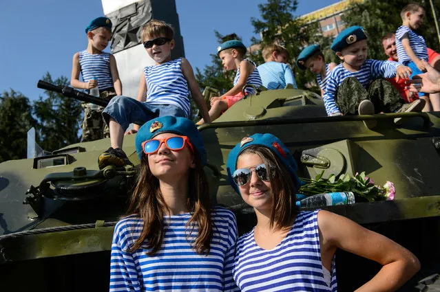 Children attend the annual paratroopers’ day celebrations. Russia’s airborne troops (“Blue Berets”) celebrate their professional holiday on the Day of Elijah the Prophet, their patron in Yekaterinburg, Russia on August 2, 2016. (Photo by TASS/Barcroft Images)