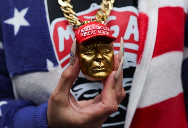 A woman holds a chain as supporters gather outside Capital One Arena, ahead of a rally for President-elect Donald Trump the day before he is scheduled to be inaugurated for a second term, in Washington, on January 19, 2025. (Photo by Amanda Perobelli/Reuters)