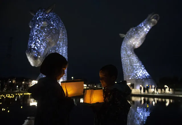 Ruby and Sonny Wallace take part in a service of reflection to honor the late Queen Elizabeth II at The Kelpies in Falkirk, Scotland, Sunday, September 18, 2022. (Photo by Lesley Martin/PA Wire via AP Photo)